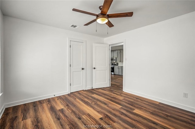 interior space with ceiling fan and dark hardwood / wood-style flooring