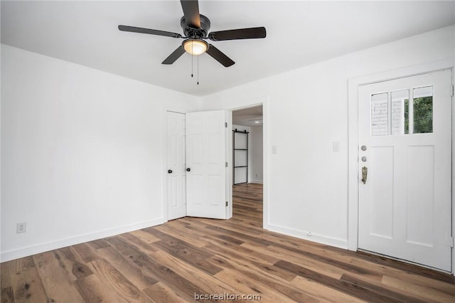 spare room with ceiling fan and dark hardwood / wood-style floors