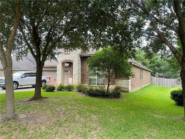 2406 Winter Trail Dr, Conroe, TX 77304 - view of front of home with a garage, brick siding, and stone siding