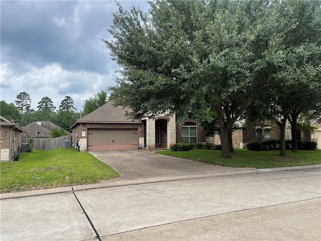 2406 Winter Trail Dr, Conroe, TX 77304 - view of property hidden behind natural elements with brick siding, a garage, and driveway