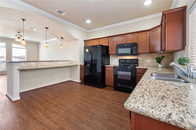 kitchen featuring visible vents, dark wood-type flooring, a peninsula, black appliances, and a sink