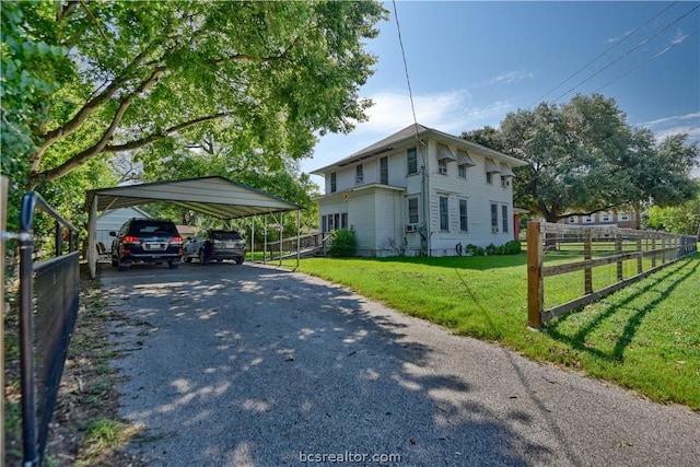 view of home's exterior featuring a carport and a lawn