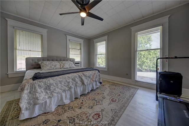 803 Holland St, Navasota, TX 77868 - bedroom with ceiling fan, ornamental molding, and light wood-type flooring