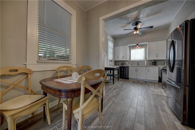 803 Holland St, Navasota, TX 77868 - dining area with ceiling fan, ornamental molding, sink, and light hardwood / wood-style flooring