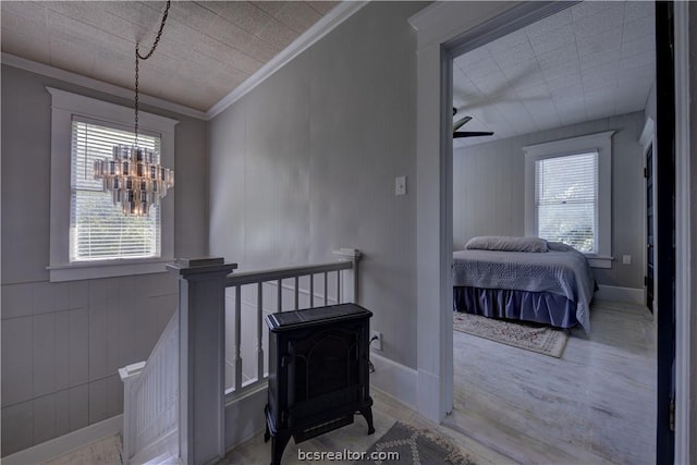 803 Holland St, Navasota, TX 77868 - corridor with a chandelier, light wood-type flooring, and ornamental molding