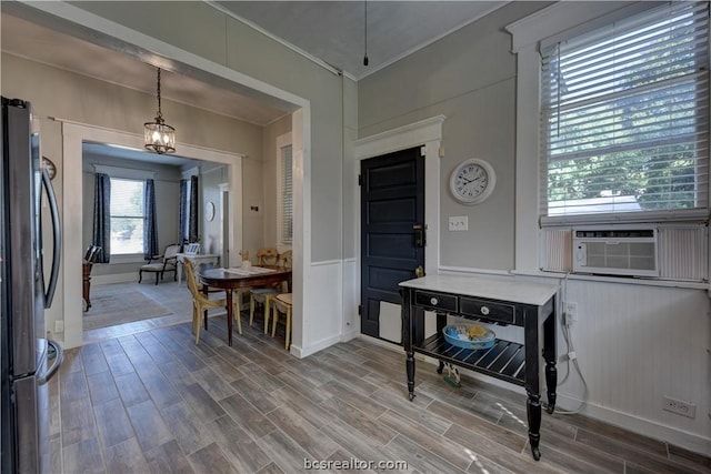 803 Holland St, Navasota, TX 77868 - kitchen featuring hardwood / wood-style floors, pendant lighting, cooling unit, crown molding, and stainless steel refrigerator