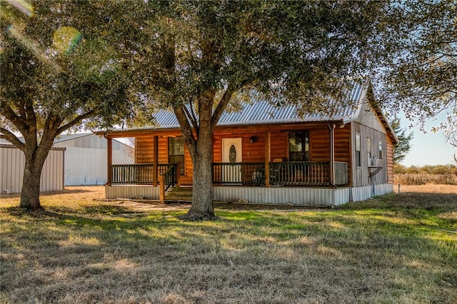 back of house with a lawn