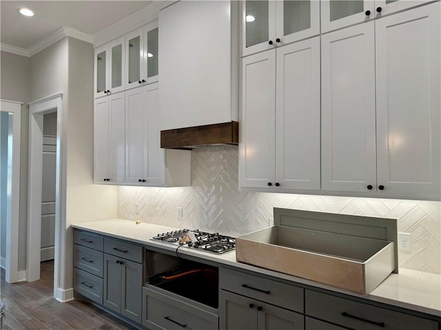 kitchen with white cabinetry, stainless steel gas cooktop, gray cabinetry, and ornamental molding