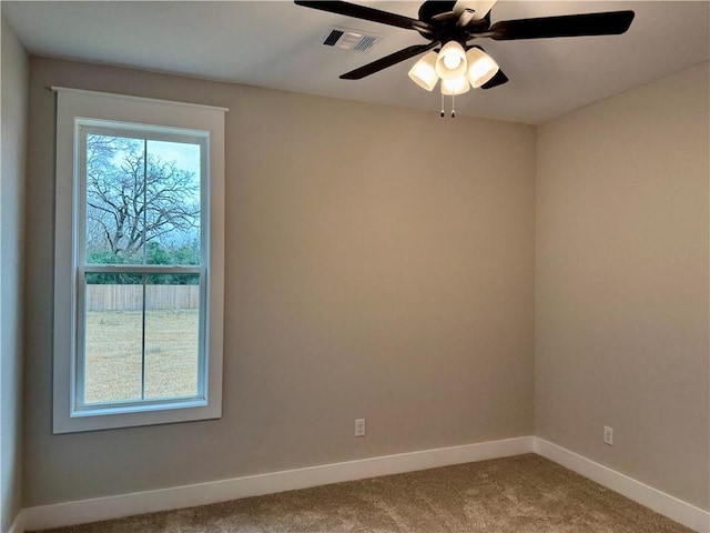 spare room featuring carpet floors and ceiling fan