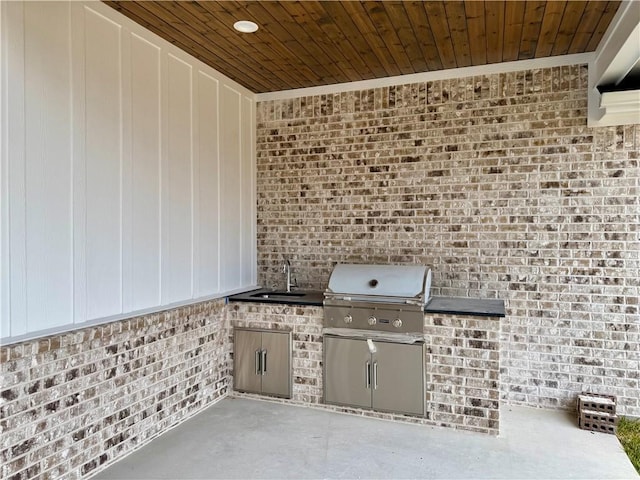 view of patio with area for grilling, exterior kitchen, and sink