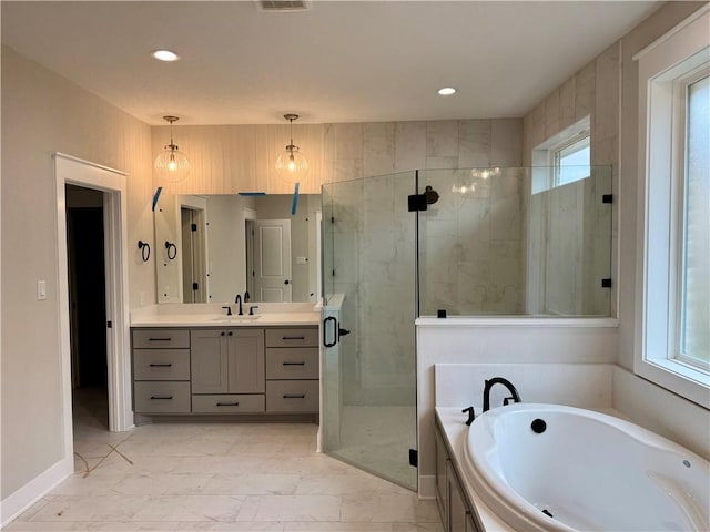 bathroom with vanity, a wealth of natural light, and separate shower and tub