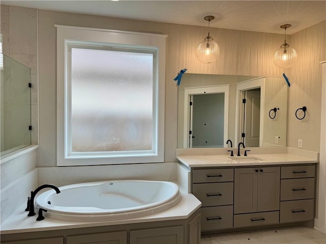 bathroom with vanity, shower with separate bathtub, and a healthy amount of sunlight