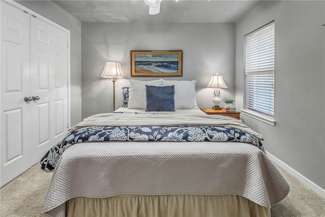 bedroom featuring carpet, ceiling fan, and a closet