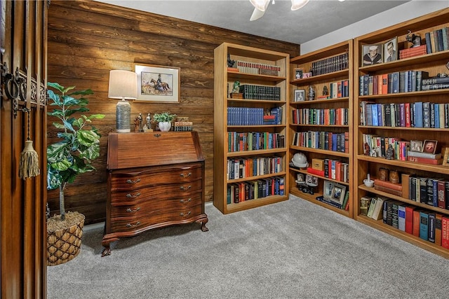 living area with log walls and light colored carpet