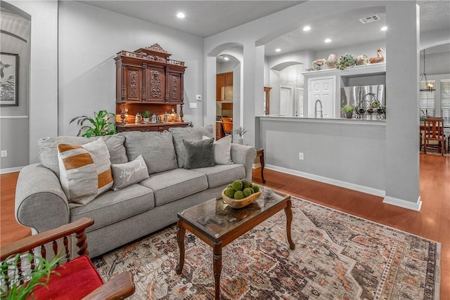 living room with sink and light wood-type flooring