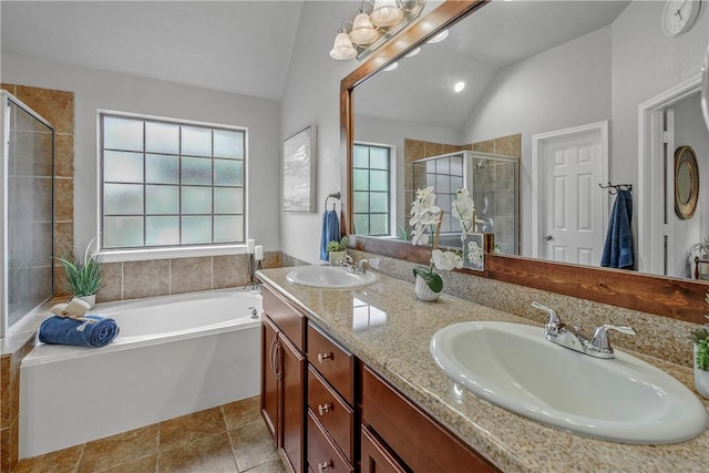 bathroom with vanity, vaulted ceiling, tile patterned floors, and plus walk in shower