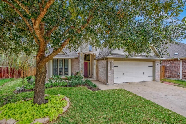 view of front of house with a garage and a front lawn