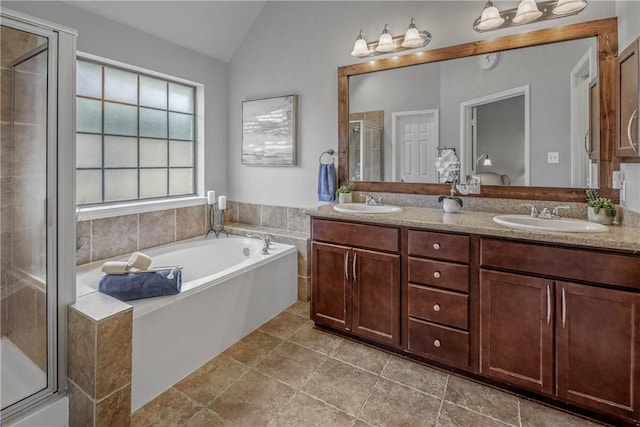 bathroom with lofted ceiling, separate shower and tub, tile patterned flooring, and vanity