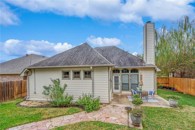 rear view of house featuring a yard and a patio