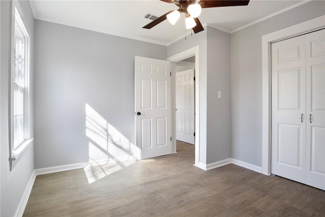 407 N Amthor St, Bellville, TX 77418 - unfurnished bedroom with hardwood / wood-style flooring, ceiling fan, ornamental molding, and a closet