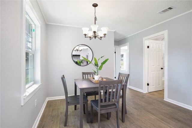 407 N Amthor St, Bellville, TX 77418 - dining area featuring ornamental molding, plenty of natural light, and dark hardwood / wood-style flooring