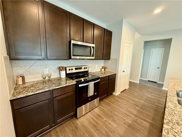4704 Los Pines Way, Bryan, TX 77807 - kitchen featuring stainless steel appliances, light wood-type flooring, baseboards, dark brown cabinetry, and recessed lighting