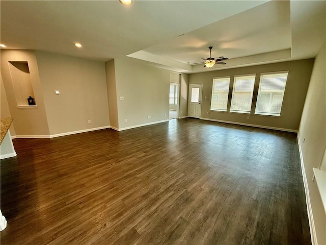 4704 Los Pines Way, Bryan, TX 77807 - empty room with a raised ceiling, a ceiling fan, baseboards, dark wood-type flooring, and recessed lighting