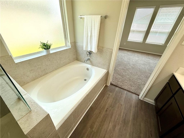 4704 Los Pines Way, Bryan, TX 77807 - bathroom with wood finished floors, a garden tub, and vanity