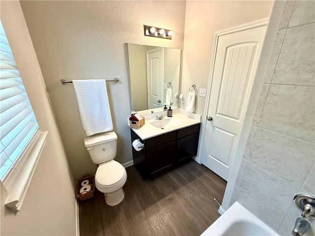 4704 Los Pines Way, Bryan, TX 77807 - full bathroom featuring wood finished floors, toilet, and vanity