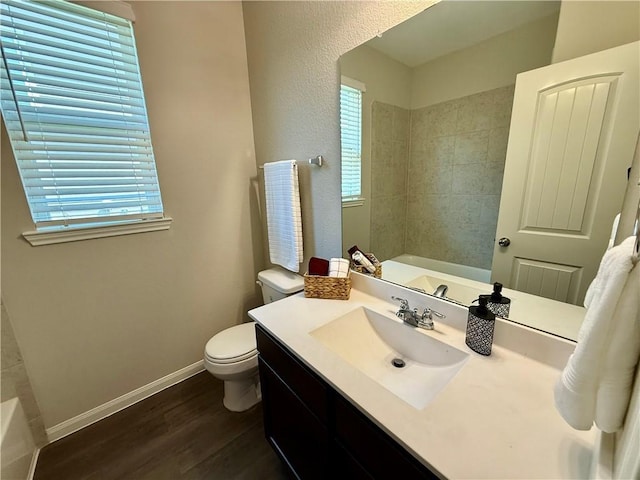 4704 Los Pines Way, Bryan, TX 77807 - full bathroom featuring wood finished floors, toilet, vanity, and baseboards