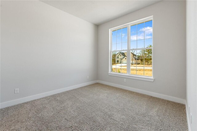 unfurnished bedroom featuring light carpet, ceiling fan, and ensuite bathroom