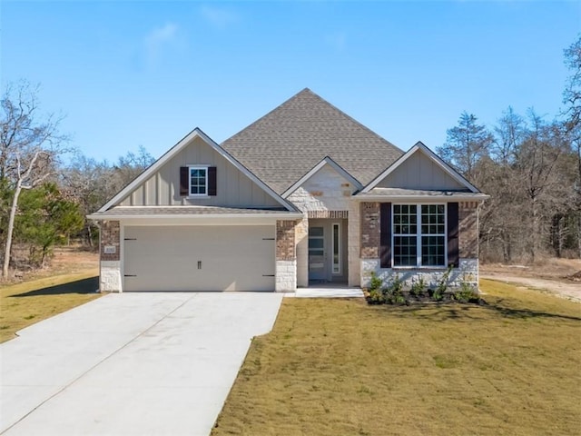 craftsman inspired home with a garage and a front lawn