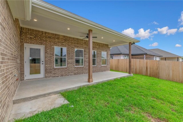 view of yard with ceiling fan and a patio