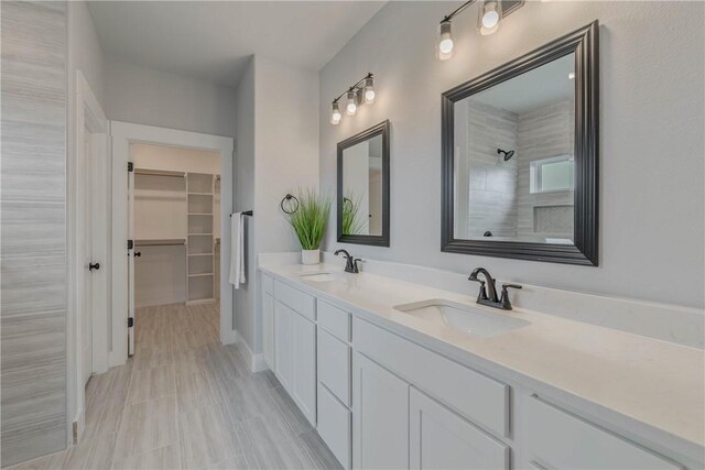 bathroom featuring vanity and tiled shower