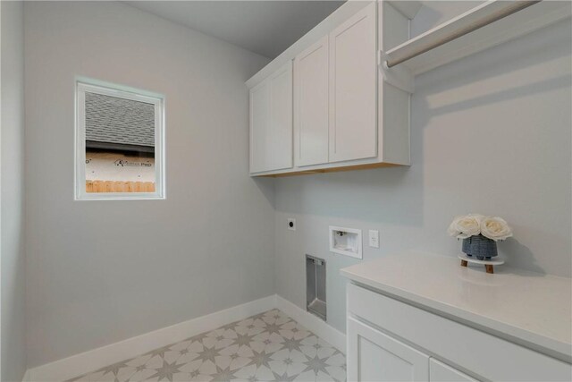 laundry area featuring hookup for an electric dryer, cabinets, and washer hookup