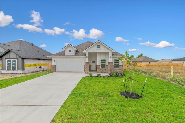 view of front of house featuring a garage and a front yard