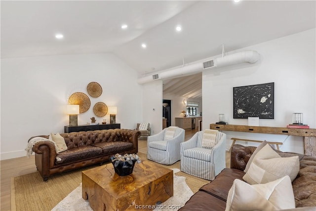 living room featuring light hardwood / wood-style flooring and lofted ceiling