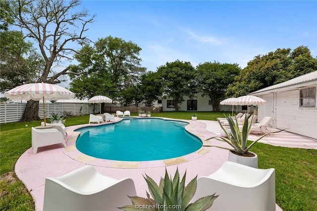 view of swimming pool featuring a yard and a patio