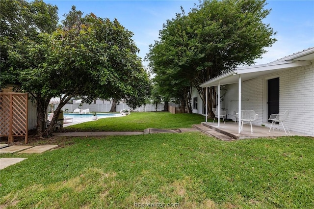 view of yard with a fenced in pool and a patio