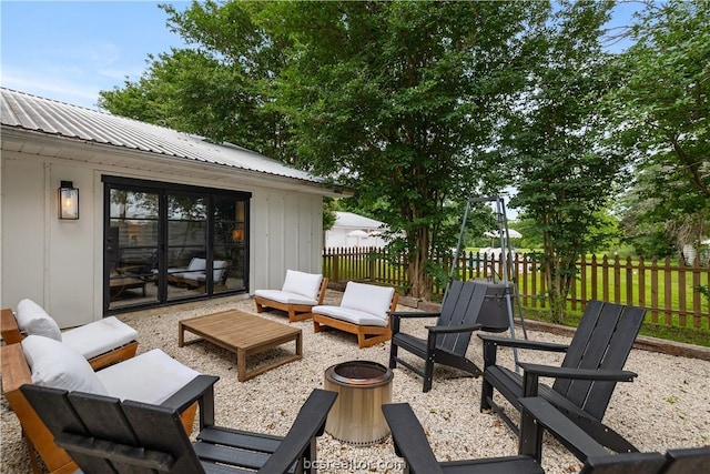 view of patio / terrace with an outdoor living space with a fire pit