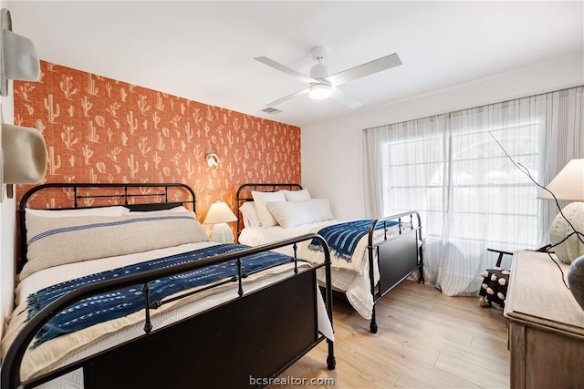 bedroom featuring light hardwood / wood-style floors and ceiling fan