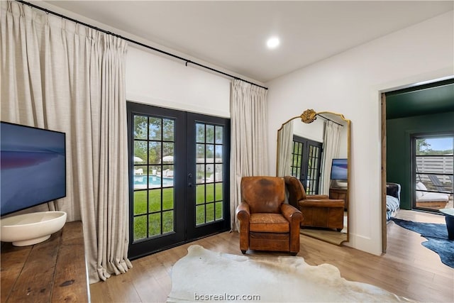 doorway to outside featuring french doors and light hardwood / wood-style floors