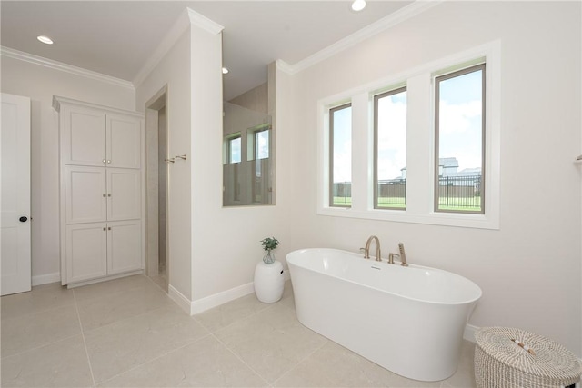 bathroom featuring a bathing tub, tile patterned flooring, and crown molding