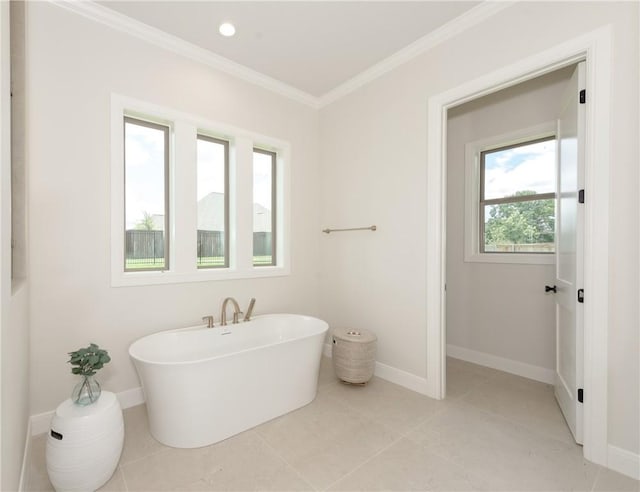 bathroom featuring tile patterned flooring, ornamental molding, and a tub