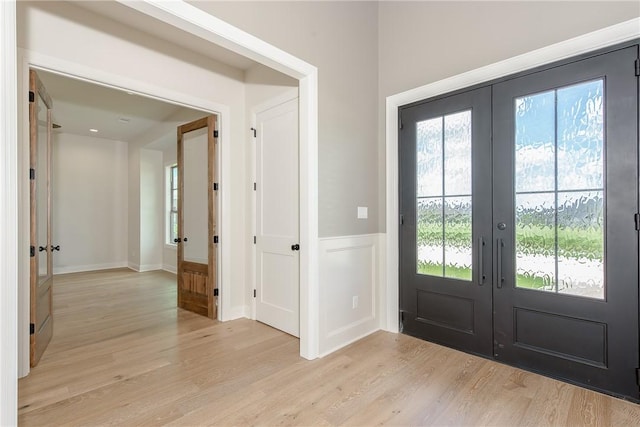 doorway featuring french doors and light hardwood / wood-style flooring