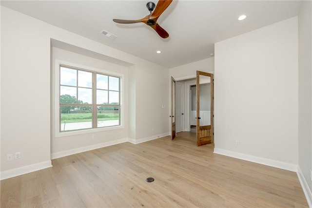 unfurnished room featuring ceiling fan and light hardwood / wood-style floors