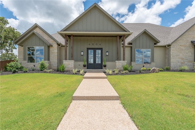 craftsman house featuring a front yard and french doors