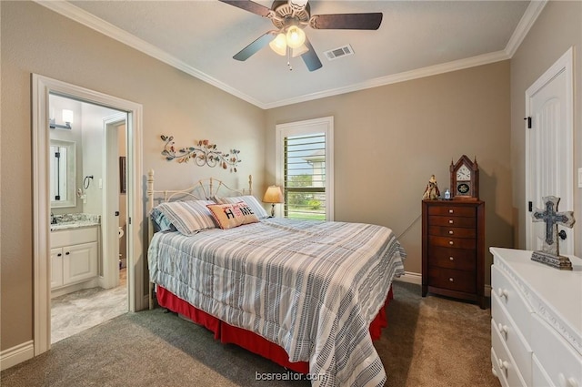 carpeted bedroom featuring ensuite bath, ceiling fan, and crown molding