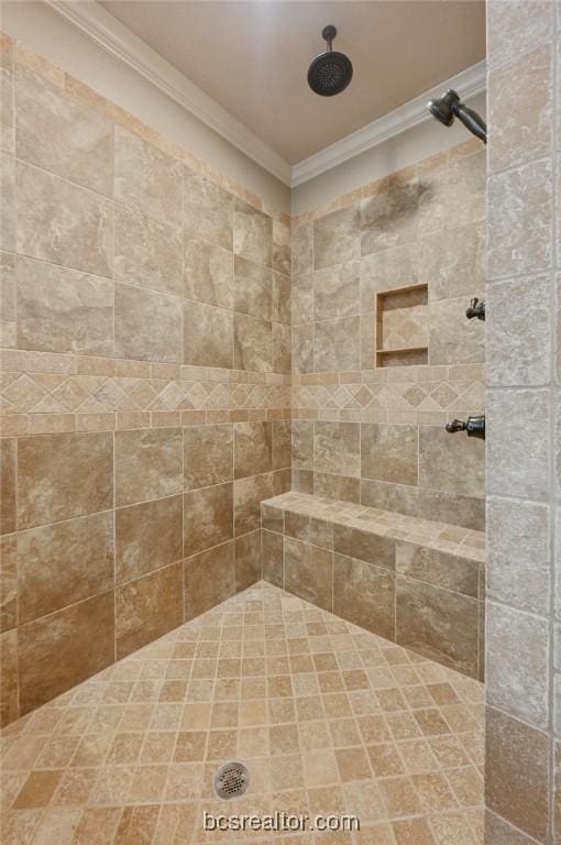 bathroom featuring a tile shower and ornamental molding