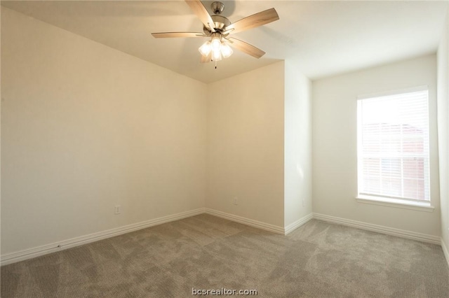 carpeted spare room featuring ceiling fan